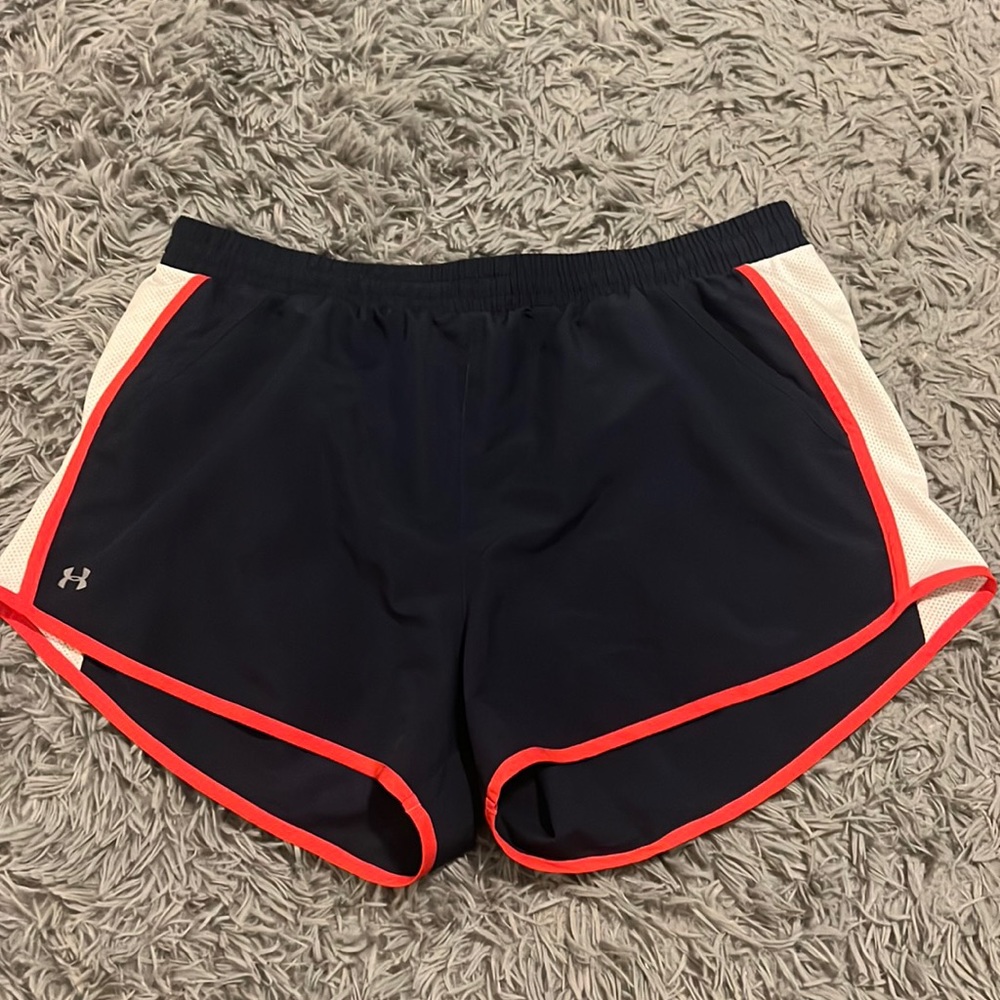 Navy, red, and white Under Armour running shorts.